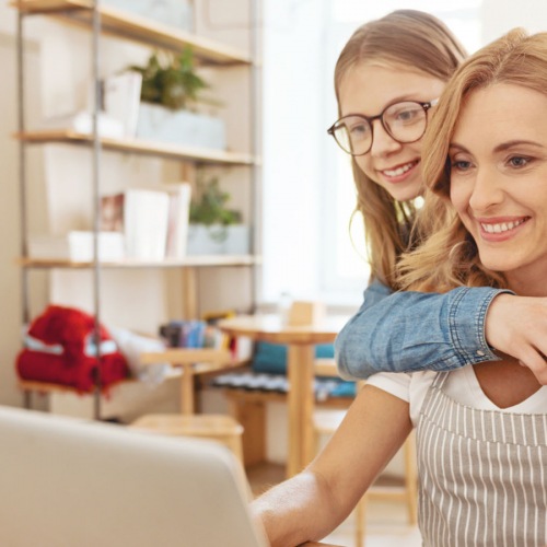 A mom and daughter on a computer